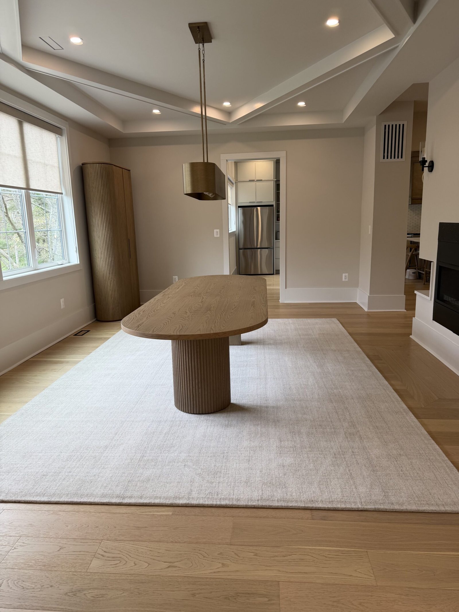 Formal dining room with oval wood table and tray ceiling