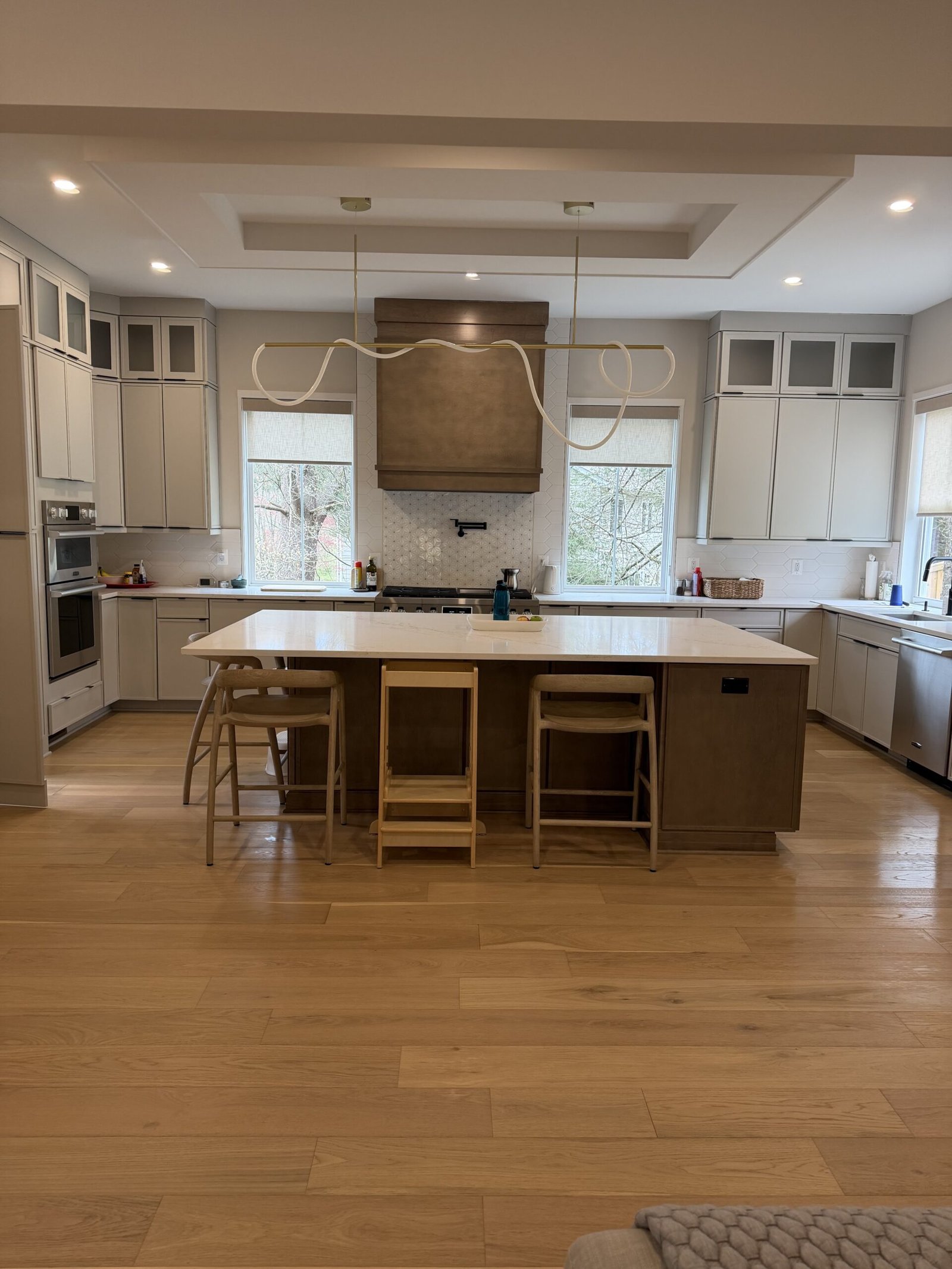 Tysons modern kitchen with large island, quartz counters, and statement pendant