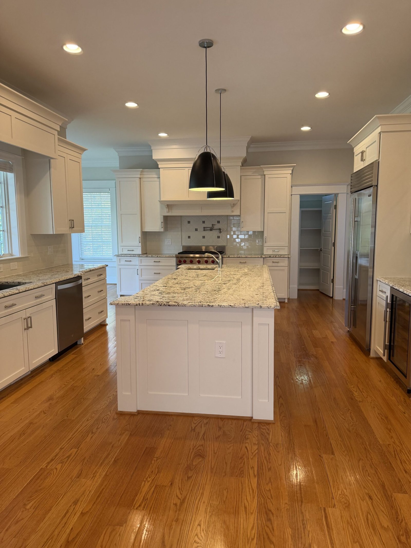 Traditional McLean kitchen with white cabinetry and granite island